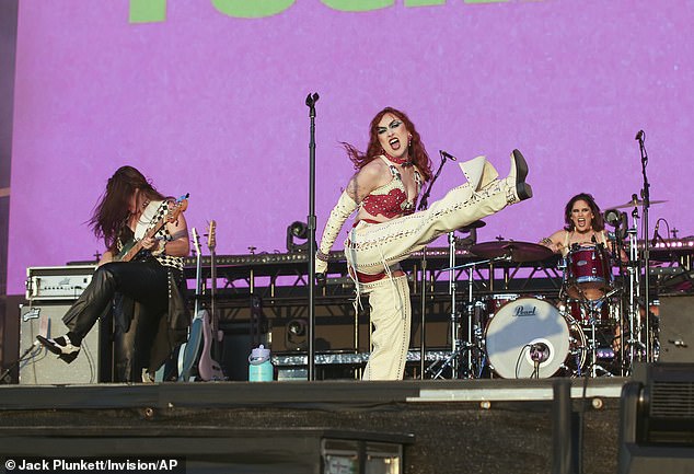 The singer stepped onto the brightly colored stage in a pair of white boots and let her wild mane of bouncy red curls cascade down her back.